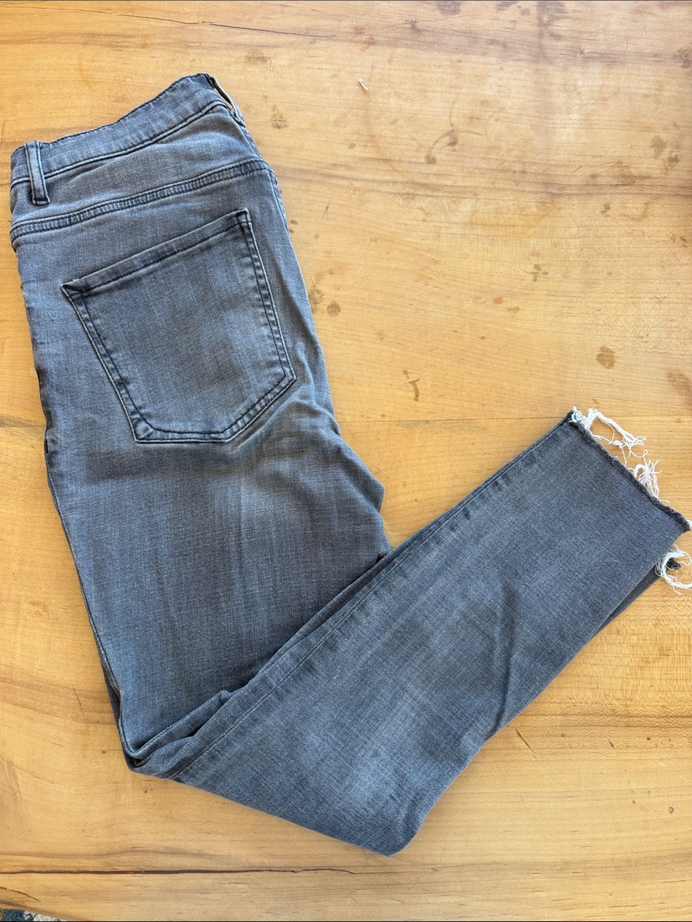 Express women’s Gray Skinny Jeans with Distressed Hem and Washed Gray Color